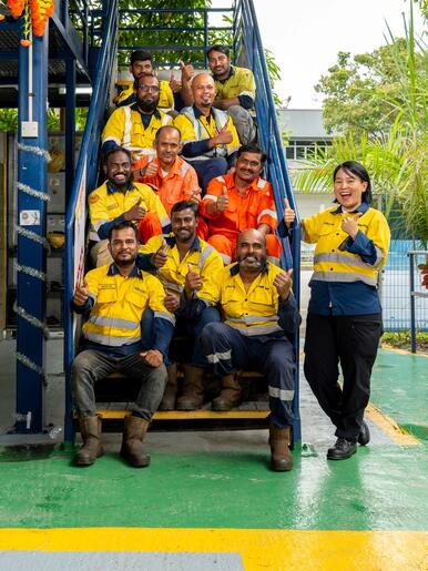 Keller employees in ppe thumbs up