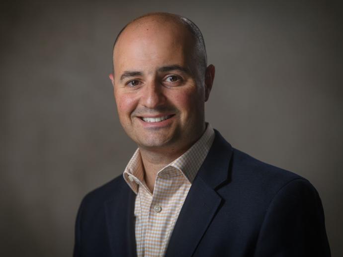 male employee in suit headshot