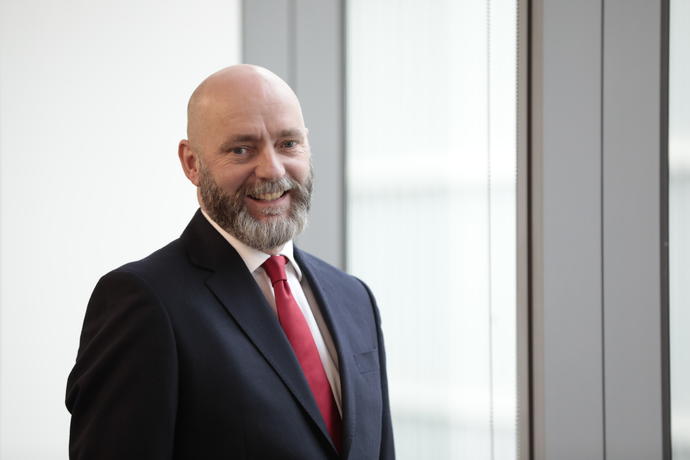 male employee in suit and red tie in office