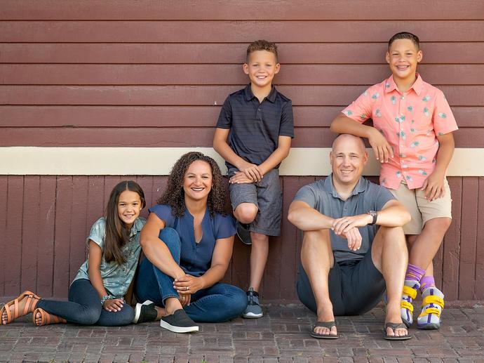 family of five smiling at camera