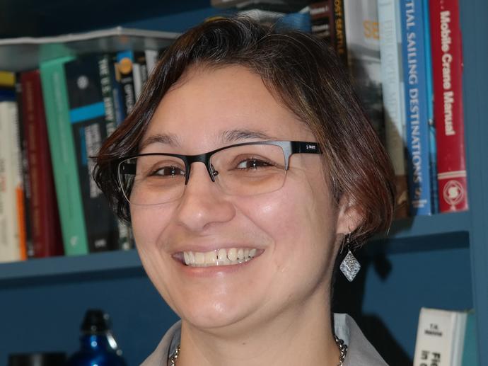 female employee smiling at camera headshot
