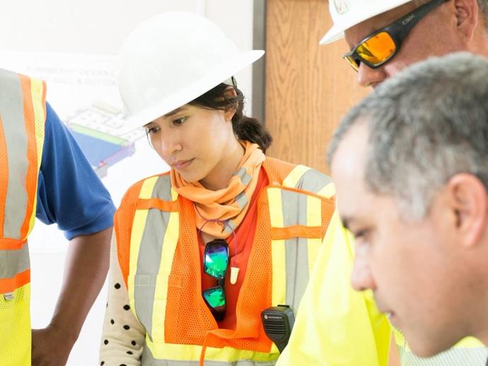 Female Keller project manager talking with colleagues