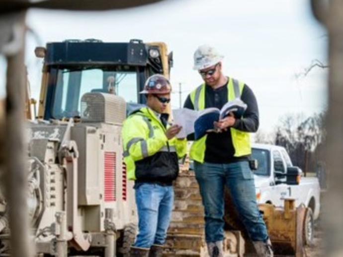 Keller employees looking at plans on site