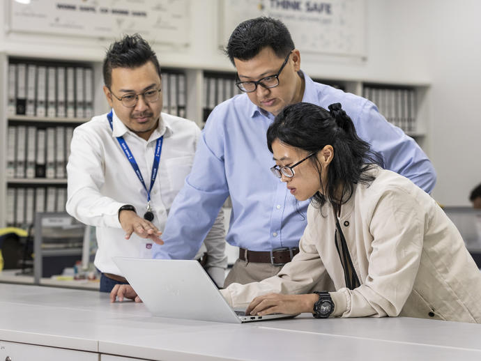 Three Keller employees working together in an office