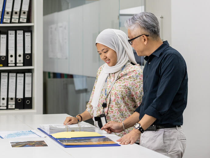 A male and a female office employee in Singapore