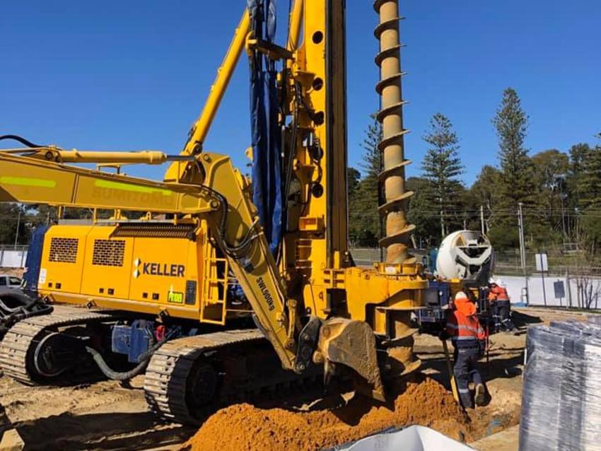 construction employee and yellow keller rig close up