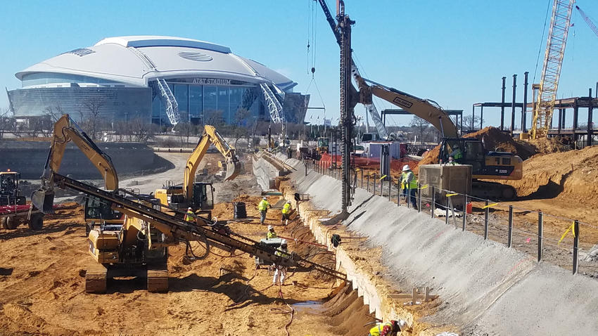 stadium surrounded by working construction site and rigs