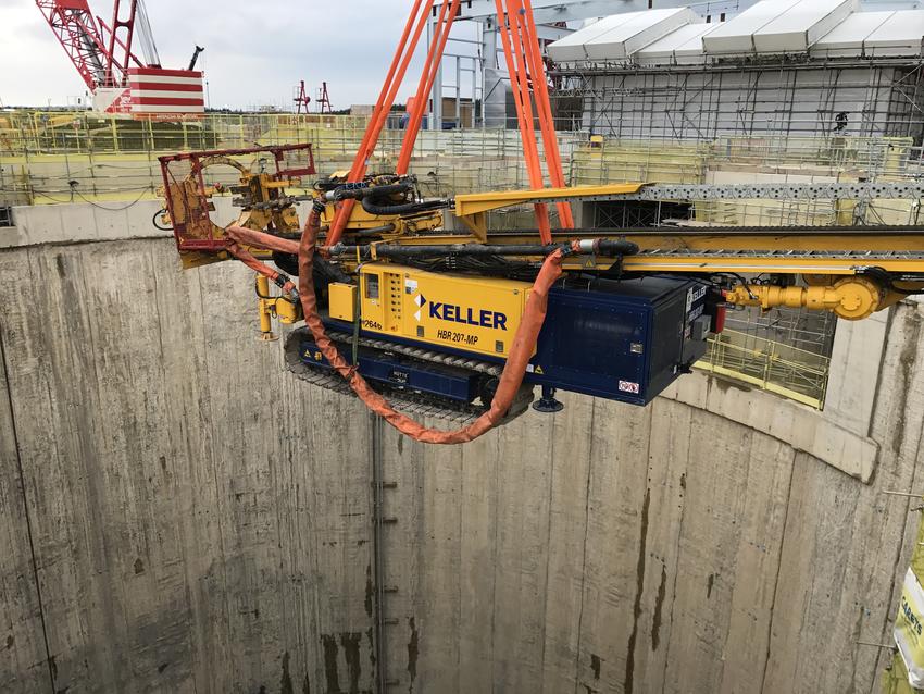 yellow keller rig being lowered into shaft