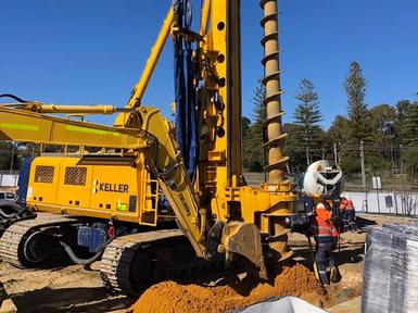 construction employee and yellow keller rig close up