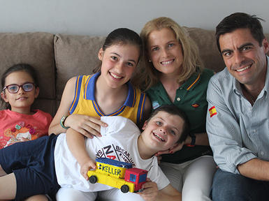 smiling family of five with keller truck toy