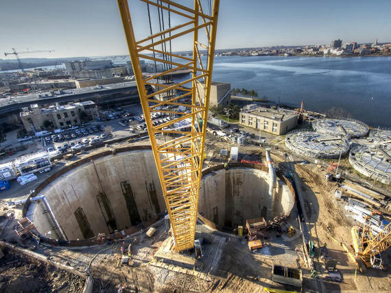 two large tunnels and yellow rig on waterside construction site