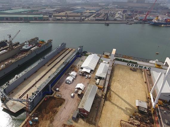 storage facilities and cranes next to docs and water