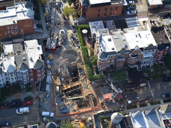 large hole on construction site between historic buildings