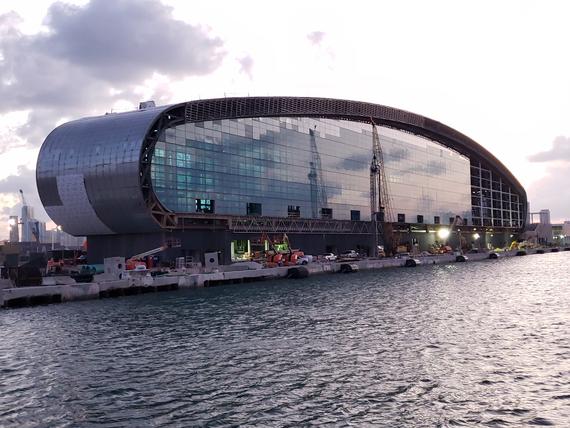 large glass cruise terminal building on water edge