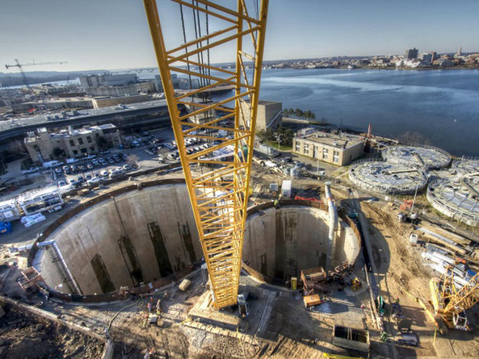 two large tunnels and yellow rig on waterside construction site