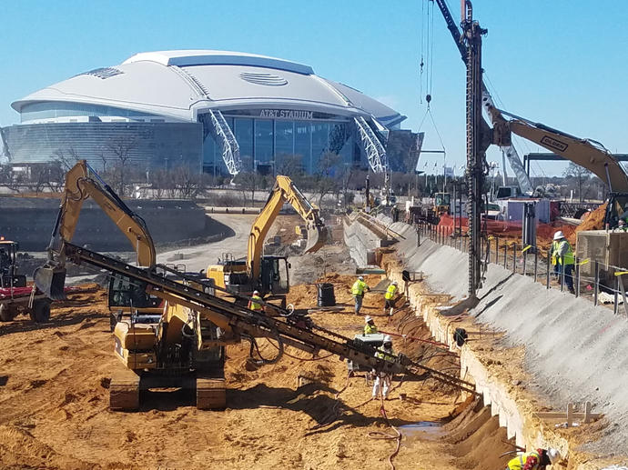 stadium surrounded by working construction site and rigs