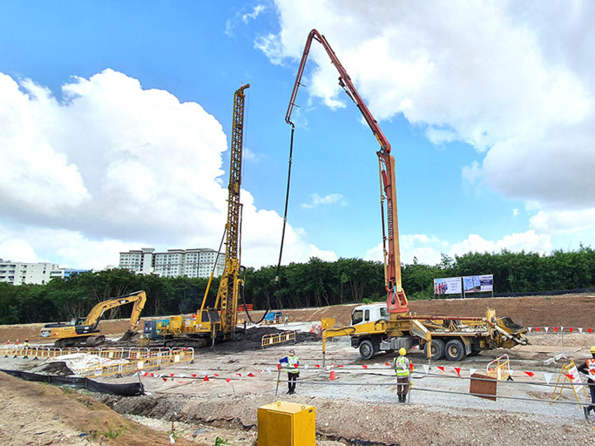 yellow keller rigs on construction site surrounded by trees and buildings