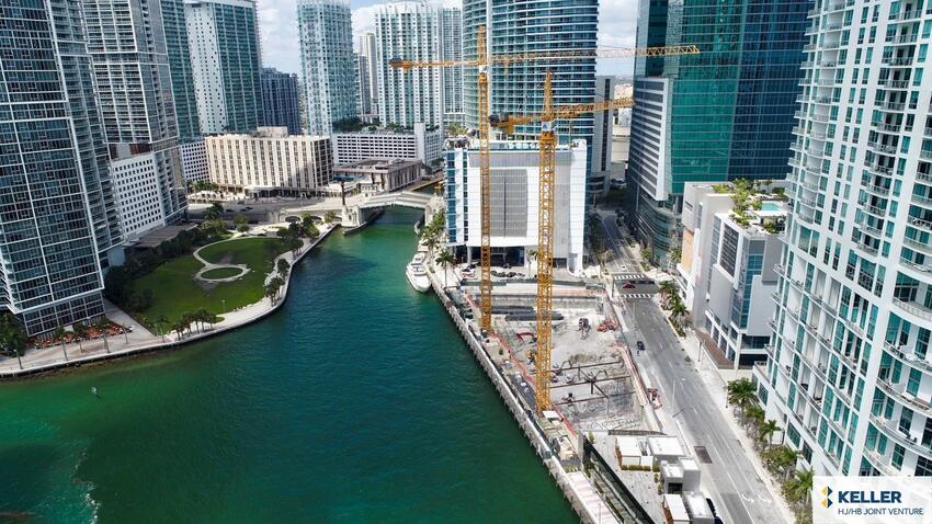 river running through skyscraper buildings