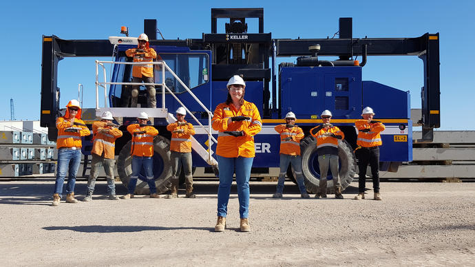 keller employees in front of equipment doing a pose