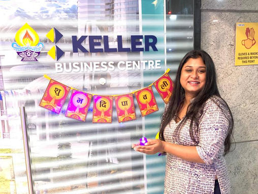 Keller employee holding candle to celebrate Diwali